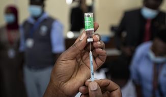 FILE—In this Friday, March 5, 2021 file photo, a nurse prepares to administer a dose of the AstraZeneca COVID-19 vaccine manufactured by the Serum Institute of India and provided through the global COVAX initiative, at Kenyatta National Hospital in Nairobi, Kenya. Kenya has ordered an immediate suspension on private importations of vaccines, citing fears that it  may lead to counterfeit inoculations getting into the country. The National Emergency Response Committee said the move is meant to ensure transparency and accountability in the process of vaccinations. (AP Photo/Ben Curtis, FIle)