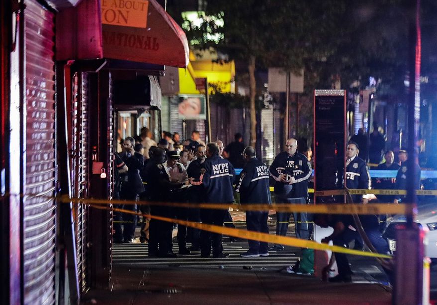 In this June 4, 2020, file photo, New York City police officers gather near the site of a shooting in the Brooklyn borough of New York.  (AP Photo/Frank Franklin II, File)
