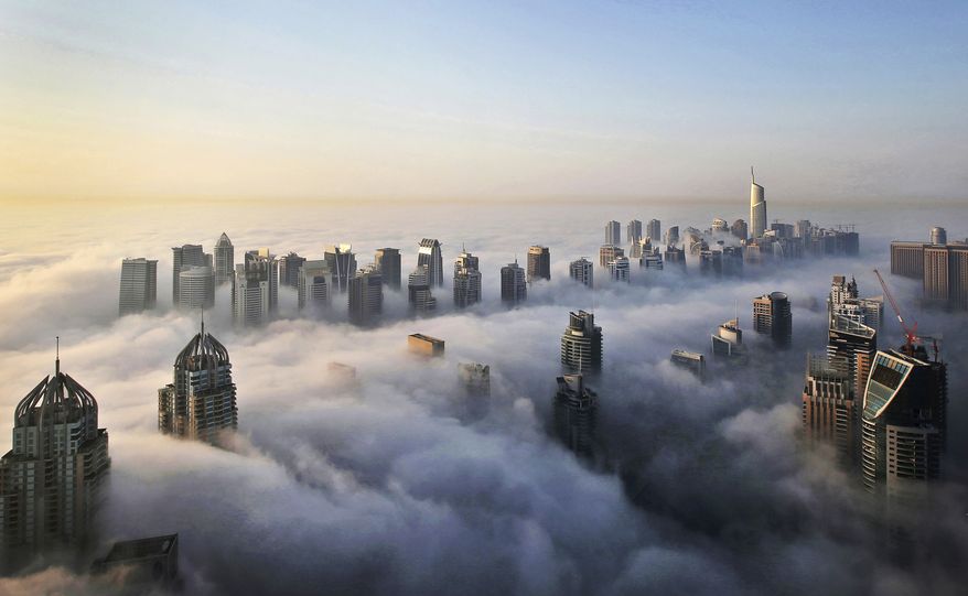 A thick blanket of early morning fog partially shrouds the skyscrapers of the Marina and Jumeirah Lake Towers districts of Dubai, United Arab Emirates. (AP Photo/Kamran Jebreili, File)