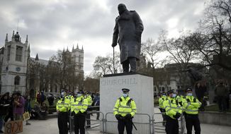 Police stand guard around the statue of wartime prime minister Winston Churchill in Parliament Square during a &#39;Kill the Bill&#39; protest in London, Saturday, April 3, 2021. The demonstration is against the contentious Police, Crime, Sentencing and Courts Bill, which is currently going through Parliament and would give police stronger powers to restrict protests. The statue had been defaced during anti-racism protests last year. (AP Photo/Matt Dunham)