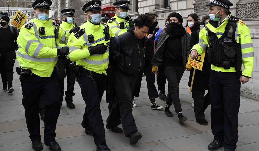 Police detain a man for blocking traffic at Parliament Square during a 'Kill the Bill' protest in London, Saturday, April 3, 2021. The demonstration is against the contentious Police, Crime, Sentencing and Courts Bill, which is currently going through Parliament and would give police stronger powers to restrict protests. (AP Photo/Alberto Pezzali)