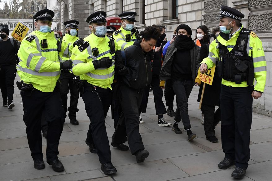 Police detain a man for blocking traffic at Parliament Square during a 'Kill the Bill' protest in London, Saturday, April 3, 2021. The demonstration is against the contentious Police, Crime, Sentencing and Courts Bill, which is currently going through Parliament and would give police stronger powers to restrict protests. (AP Photo/Alberto Pezzali)