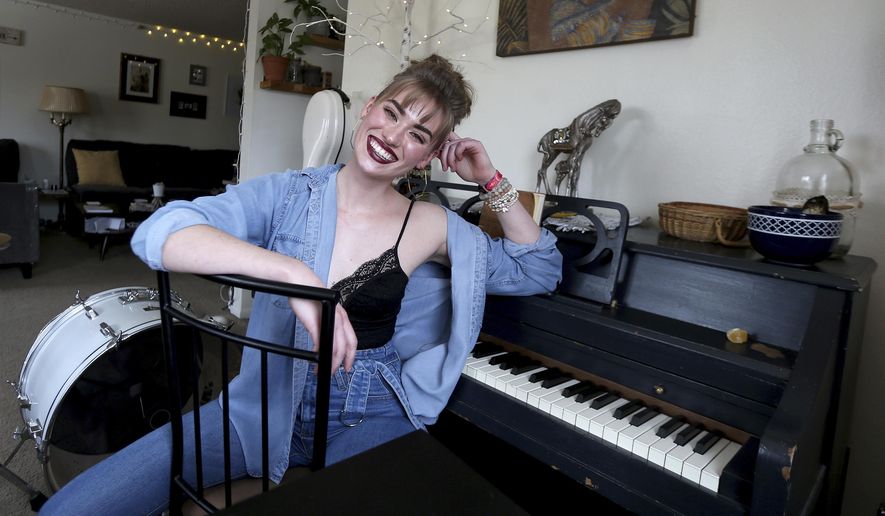 Musician Jonni Marie Wiltse, 23, poses for a photo at her home in Cheyenne, Wyo., Friday, March 26, 2021. Wiltse, who has had two back surgeries, has found inspiration in music. She can be found playing at Dillinger&#x27;s open mic nights every Thursday night. (Michael Cummo/The Wyoming Tribune Eagle via AP)