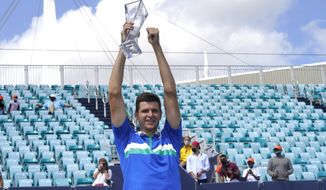 Hubert Hurkacz of Poland poses with the trophy after defeating Yannik Sinner of Italy during the finals of the Miami Open tennis tournament, Sunday, April 4, 2021, in Miami Gardens, Fla. Hurkacz won 7-6 (4), 6-4. (AP Photo/Lynne Sladky)