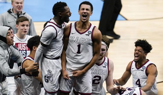Gonzaga guard Jalen Suggs (1) celebrates making the game winning basket with Joel Ayayi, left, against UCLA during overtime in a men&#39;s Final Four NCAA college basketball tournament semifinal game, Saturday, April 3, 2021, at Lucas Oil Stadium in Indianapolis. Gonzaga won 93-90. (AP Photo/Michael Conroy)