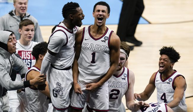 Gonzaga guard Jalen Suggs (1) celebrates making the game winning basket with Joel Ayayi, left, against UCLA during overtime in a men's Final Four NCAA college basketball tournament semifinal game, Saturday, April 3, 2021, at Lucas Oil Stadium in Indianapolis. Gonzaga won 93-90. (AP Photo/Michael Conroy)
