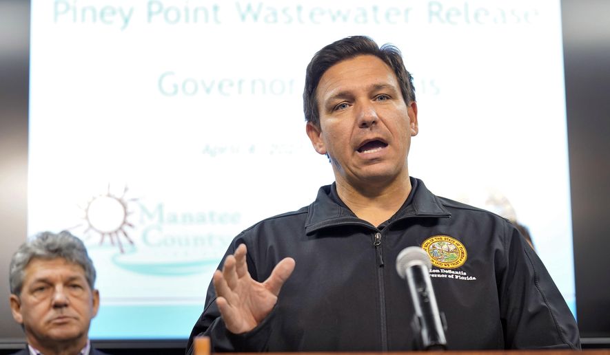Florida Gov. Ron DeSantis gestures during a news conference Sunday, April 4, 2021, at the Manatee County Emergency Management office in Palmetto, Fla. DeSantis declared a state of emergency Saturday after a leak at a large pond of wastewater threatened to flood roads and burst a system that stores polluted water. (AP Photo/Chris O&#39;Meara)