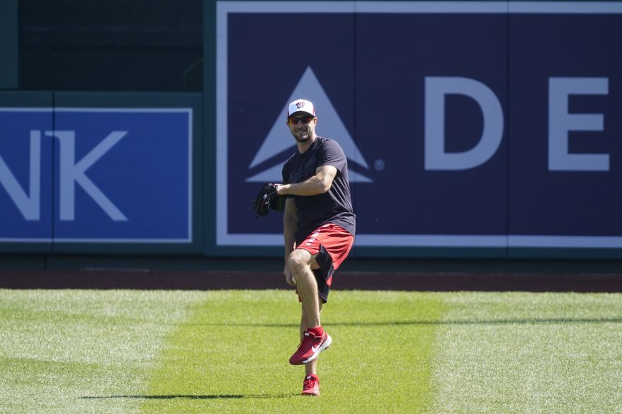 Washington Nationals starting pitcher Max Scherzer throws during a baseball workout at Nationals Park, Monday, April 5, 2021, in Washington. The Nationals are scheduled to play the Braves on Tuesday. (AP Photo/Alex Brandon)