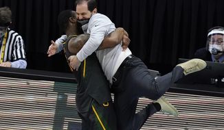 Baylor head coach Scott Drew gets a hug from guard Mark Vital at the end of the championship game against Gonzaga in the men&#39;s Final Four NCAA college basketball tournament, Monday, April 5, 2021, at Lucas Oil Stadium in Indianapolis. Baylor won 86-70. (AP Photo/Darron Cummings)