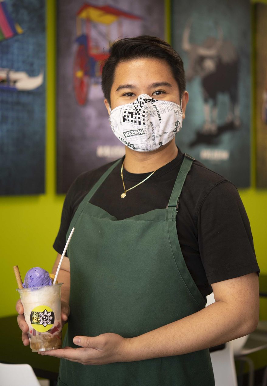 Joe Got Prince who works for the the Goyenechea family at the Maemax Market and restaurant holds a Halo-Halo dessert in La Vergne, Tenn., on March 25, 2021. There are dozens of global markets in Middle Tennessee, each selling hard-to-find foods and ingredients from cuisines around the world. Shops like Maemax represent a growing industry nationally — while the overall American supermarket industry grew just 0.6 percent from 2015 to 2020, the globally-focused supermarket industry grew 3 percent over that same period.(Stephanie Amador/The Tennessean via AP)