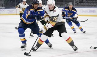 Vegas Golden Knights&#x27; Reilly Smith (19) controls the puck as St. Louis Blues&#x27; Brayden Schenn (10) defends during the third period of an NHL hockey game Monday, April 5, 2021, in St. Louis. (AP Photo/Jeff Roberson)
