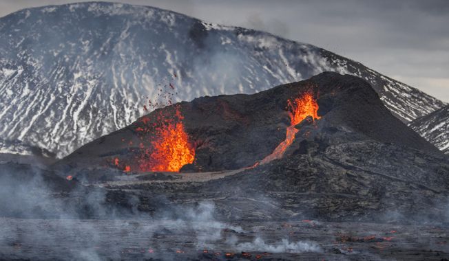 The Lava flows from an eruption of a volcano on the Reykjanes Peninsula in southwestern Iceland on Wednesday, March 31, 2021. Iceland&#x27;s latest volcano eruption is still attracting crowds of people hoping to get close to the gentle lava flows. (AP Photo/Marco Di Marco)
