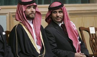 FILE - In this Nov. 28, 2006, file photo, Prince Hamzah Bin Al-Hussein, right, and Prince Hashem Bin Al-Hussein, left, half brothers of King Abdullah II of Jordan, attend the opening of the parliament in Amman, Jordan. Prince Hamzah said in a recording released Monday, April 5, 2021, that he will defy government threats ordering him to stay at home and refrain from public statements following accusations he was behind a plot to destabilize the kingdom. (AP Photo/Mohammad abu Ghosh, File)