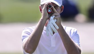 Georgia Tech amateur Tyler Strafaci checks the distance to the third green as he prepares to tee off on the third hole during his practice round for the Masters at Augusta National Golf Club on Monday, April 5, 2021, in Augusta, Ga. (Curtis Compton/Atlanta Journal-Constitution via AP)