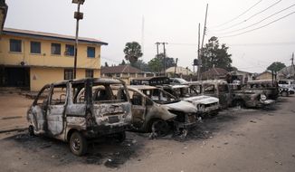 Burned vehicles are parked outside the police command headquarters in Owerri, Nigeria, on Monday, April 5, 2021. Hundreds of inmates escaped from a prison in the southeastern Nigerian city after a series of coordinated attacks, according to government officials. (AP Photo/David Dosunmu)