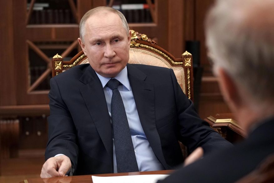 Russian President Vladimir Putin listens to General Director of the Russian Direct Investment Fund Krill Dmitriev at the Kremlin in Moscow, Russia, Friday, April 2, 2021. (Alexei Druzhinin, Sputnik, Kremlin Pool Photo via AP)
