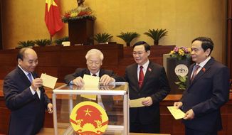 Vietnamese leaders cast ballot to elect new Prime Minister, from left, President Nguyen Xuan Phuc, Communist General Secretary Nguyen Phu Trong, Chairman of National Assembly Vuong Dinh Hue and newly elected Prime Minister Pham Minh Chinh in Hanoi, Vietnam on Monday, April 5, 2021. Vietnam&#39;s legislature voted Monday to make Pham Minh Chinh, a member of the Communist party&#39;s central committee for personnel and organization, the country&#39;s next prime minister. Outgoing Prime Minister Nguyen Xuan Phuc was appointed the new president.(Nguyen Phuong Hoa/VNA via AP)