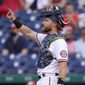 Washington Nationals catcher Jonathan Lucroy gestures in the seventh inning of an opening day baseball game against the Atlanta Braves at Nationals Park, Tuesday, April 6, 2021, in Washington. (AP Photo/Alex Brandon)