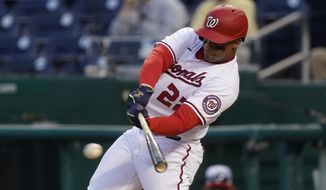 Washington Nationals&#39; Juan Soto singles in the ninth inning of an opening day baseball game against the Atlanta Braves at Nationals Park, Tuesday, April 6, 2021, in Washington. Victor Robles scored on the play, and Washington won 6-5. (AP Photo/Alex Brandon)