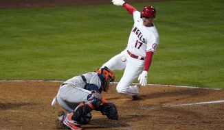 Los Angeles Angels&#x27; Shohei Ohtani (17) scores on a fielder&#x27;s choice past Houston Astros catcher Martin Maldonado on a ground ball by Jared Walsh during the eighth inning of a baseball game, Monday, April 5, 2021, in Anaheim, Calif. (AP Photo/Marcio Jose Sanchez)