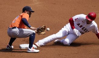 Los Angeles Angels&#x27; Shohei Ohtani, right, steals second as Houston Astros second baseman Jose Altuve takes a late throw during the first inning of a baseball game Tuesday, April 6, 2021, in Anaheim, Calif. (AP Photo/Mark J. Terrill)