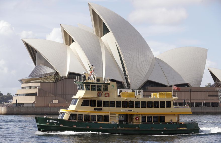 A ferry sails past the Opera House in Sydney, Australia, Tuesday, April 6, 2021. New Zealand announced the start date for a long-anticipated travel bubble between Australia and New Zealand that will allow people to travel between the two countries without going through quarantine, allowing families to reunite and giving a big boost to the struggling tourism industry will begin April 19. (AP Photo/Rick Rycroft)