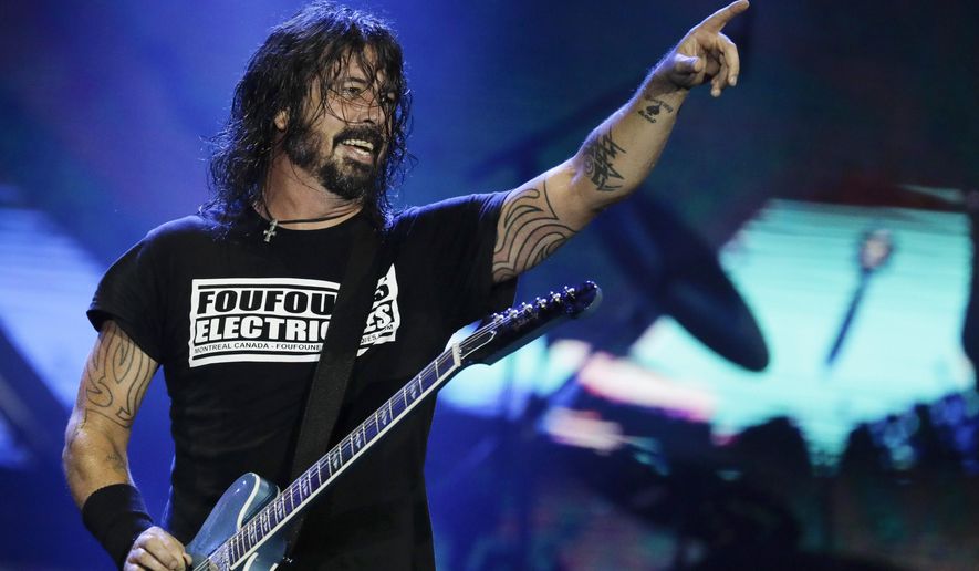 FILE - In this Sept. 29, 2019, file photo, Dave Grohl of the band Foo Fighters performs at the Rock in Rio music festival in Rio de Janeiro, Brazil.  Grohl’s memoir “The Storyteller” will come out Oct. 5, Dey Street Books announced Tuesday. The 52-year-old Grohl will reflect on everything from his childhood to his years with Nirvana and Foo Fighters. (AP Photo/Leo Correa, File)
