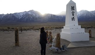 FILE - In this Feb. 17, 2020, file photo Lori Matsumura visits the cemetery at the Manzanar National Historic Site near Independence, Calif. The auction of a series of sketches purportedly drawn by an artist at the Japanese internment camp has been canceled Tuesday, April 6, 2021, after groups protested it was offensive and immoral to profit off the misery of incarcerated people. Matsumura, the granddaughter of Giichi who recently reburied her grandfather&#39;s remains after a hiker unearthed his skeleton in 2019, thought the sketches could be by her late father, Masaru, or another family member. (AP Photo/Brian Melley, File)