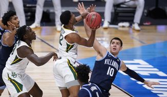 Baylor guard Jared Butler (12) shoots on Villanova forward Cole Swider (10) in the first half of a Sweet 16 game in the NCAA men&#39;s college basketball tournament at Hinkle Fieldhouse in Indianapolis, Saturday, March 27, 2021. (AP Photo/Mike Conroy)