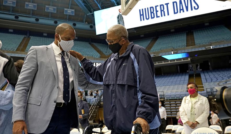 North Carolina head coach Hubert Davis, left, is congratulated by former North Carolina player Bill Chamberlain following a news conference at the University of North Carolina in Chapel Hill, N.C., Tuesday, April 6, 2021. Davis was named the Tar Heels&#39; new NCAA men&#39;s basketball coach following the retirement of Roy Williams. (AP Photo/Gerry Broome)