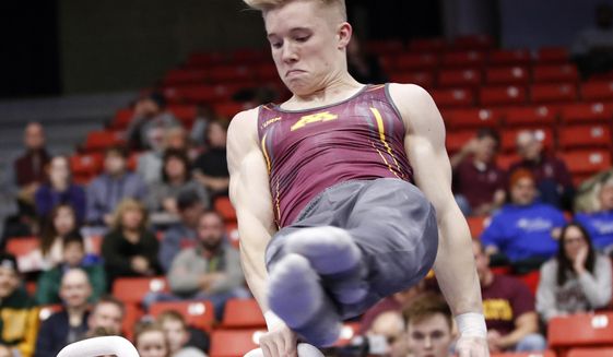 In this Jan. 18, 2020, file photo, Minnesota&#39;s Shane Wiskus competes during an NCAA gymnastics meet in Chicago. Wiskus is an Olympic hopeful who moved to the Olympic Training Center (OTC) in Colorado Springs after his college program, Minnesota, announced it would be shutting down its program. (AP Photo/Kamil Krzaczynsk, File). **FILE**