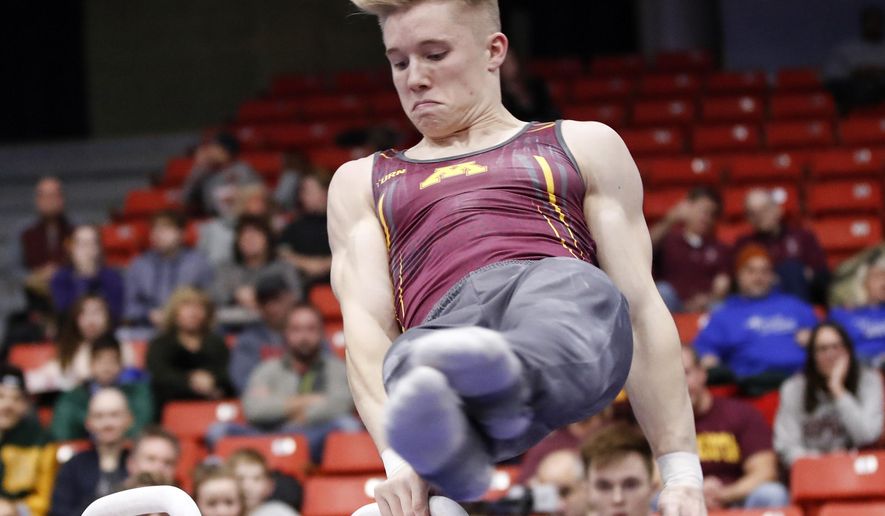 In this Jan. 18, 2020, file photo, Minnesota&#x27;s Shane Wiskus competes during an NCAA gymnastics meet in Chicago. Wiskus is an Olympic hopeful who moved to the Olympic Training Center (OTC) in Colorado Springs after his college program, Minnesota, announced it would be shutting down its program. (AP Photo/Kamil Krzaczynsk, File). **FILE**