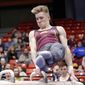 In this Jan. 18, 2020, file photo, Minnesota&#39;s Shane Wiskus competes during an NCAA gymnastics meet in Chicago. Wiskus is an Olympic hopeful who moved to the Olympic Training Center (OTC) in Colorado Springs after his college program, Minnesota, announced it would be shutting down its program. (AP Photo/Kamil Krzaczynsk, File). **FILE**