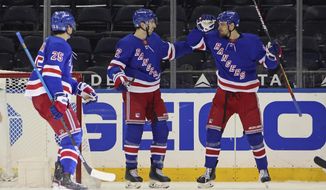 New York Rangers&#x27; Pavel Buchnevich, right, celebrates his third-period goal against the Pittsburgh Penguins with Libor Hajek, left, and Filip Chytil (72 during an NHL hockey game Tuesday, April 6, 2021, in New York. (Bruce Bennett/Pool Photo via AP)