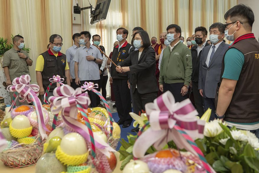 In this photo released by the Taiwan Presidential Office, Taiwan President Tsai Ing-wen offers joss sticks at a memorial for victims of Friday's train derailment in Hualien, eastern Taiwan on Saturday, April 3, 2021. Prosecutors in Taiwan on Saturday sought an arrest warrant for the owner of an unmanned truck that rolled onto a train track and caused the country's worst rail disaster in decades, killing dozens and injuring more. (Taiwan Presidential Office via AP)