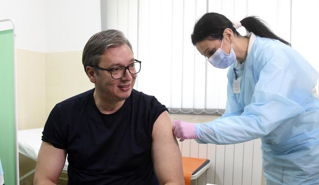 In this photo provided by the Serbian Presidential Press Service, Serbian President Aleksandar Vucic receives a dose of the Chinese Sinopharm vaccine in the village of Rudna Glava, Serbia, Tuesday, April 6, 2021. Vucic finally rolled up his sleeve for a coronavirus vaccine Tuesday and to encourage his country&#x27;s increasingly skeptical Serbs to get vaccinated themselves. (Serbian Presidential Press Service via AP)
