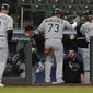 Chicago White Sox&#39;s Yermin Mercedes (73) and Yoan Moncada (10) are greeted at the dugout by pitching coach Ethan Katz (52) after they scored on a two-RBI single hit by Yasmani Grandal during the fifth inning of a baseball game against the Seattle Mariners, Monday, April 5, 2021, in Seattle. (AP Photo/Ted S. Warren)
