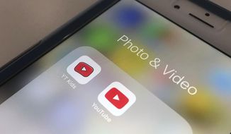 In this April 25, 2018, file photo, the YouTube app and YouTube Kids app are displayed on an iPhone in New York. (AP Photo/Jenny Kane, File)