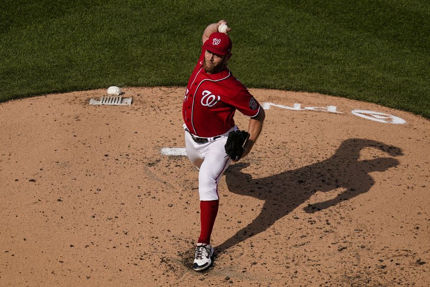 Washington Nationals starting pitcher Stephen Strasburg throws during the third inning of the second baseball game of a doubleheader at Nationals Park, Wednesday, April 7, 2021, in Washington. (AP Photo/Alex Brandon)