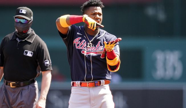 Atlanta Braves&#x27; Ronald Acuna Jr. celebrates his double during the first inning in the first baseball game of a doubleheader against the Washington Nationals at Nationals Park, Wednesday, April 7, 2021, in Washington. (AP Photo/Alex Brandon)