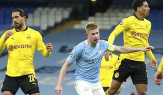 Manchester City&#39;s Kevin De Bruyne, center, celebrates after scoring his side&#39;s first goal during the Champions League, first leg, quarterfinal soccer match between Manchester City and Borussia Dortmund at the Etihad stadium in Manchester, Tuesday, April 6, 2021. (AP Photo/Dave Thompson)