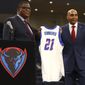 DePaul University&#39;s new men&#39;s basketball head coach Tony Stubblefield holds a jersey accompanied by director of athletics DeWayne Peevy, left, during a press conference, Wednesday, April 7, 2021 in Chicago. (AP Photo/Shafkat Anowar)
