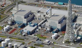 FILE - This Sept. 30, 2017, aerial file photo shows the reactors of No. 6, right, and No. 7, left, at Kashiwazaki-Kariwa nuclear power plant, on the northern Japanese coast in Niigata prefecture. The operator of the Fukushima nuclear plant that was destroyed in a 2011 disaster said Wednesday it will accept a penalty imposed by regulators over sloppy anti-terrorism measures at another nuclear plant it runs, a step that will prevent its desperately sought restart of the facility for at least a year. (Kyodo News via AP, File)