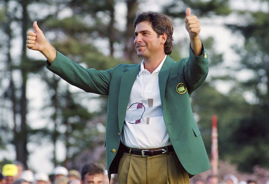 FILE - In this April 12, 1992, file photo, Fred Couples gives the thumbs-up after getting his traditional green jacket after winning the 1992 Masters golf tournament at the Augusta National Golf Club in Augusta, Ga. Couples brought the driver he used that week to Augusta National for a display of clubs used by Masters champions. (AP Photo/Lenny Ignelzi, File)