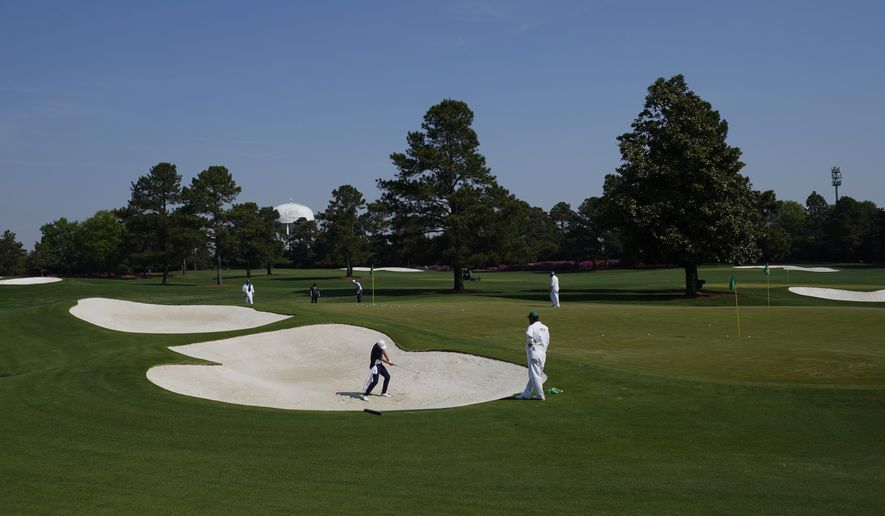 Jordan Spieth hits out of a bunker on the driving range during a practice round for the Masters golf tournament on Wednesday, April 7, 2021, in Augusta, Ga. (AP Photo/Charlie Riedel)