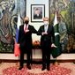In this photo handout photo released by Pakistan&#39;s Ministry of Foreign Affairs, Russia&#39;s Foreign Minister Sergey Lavrov, left, bumps elbows with his Pakistani counterpart Shah Mahmood Qureshi prior their meeting, in Islamabad, Pakistan, Wednesday, April 7, 2021. Russia&#39;s foreign minister is in Pakistan for a two-day visit expected to focus on efforts to bring peace to neighboring Afghanistan. Lavrov&#39;s visit comes as a May 1 deadline for U.S. troops to leave Afghanistan in line with a deal Washington signed a year ago with the Taliban seems increasingly unlikely. (Pakistan&#39;s Ministry of Foreign Affairs via AP)