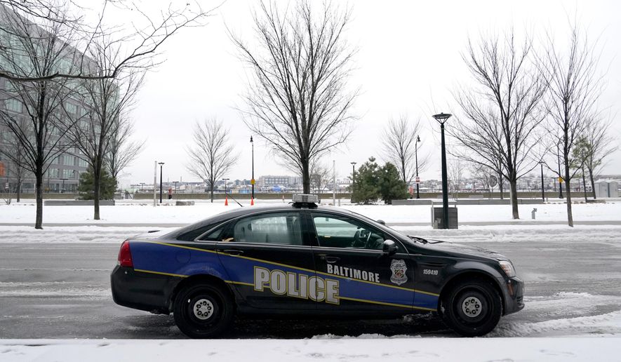 In this Thursday, Feb. 18, 2021, file photo, a Baltimore police cruiser is seen parked near a building while officers check on a call. A comprehensive package of police reform measures cleared the Maryland General Assembly on Wednesday, April 7, 2021, including repeal of police job protections long cited as a barricade to accountability. (AP Photo/Julio Cortez, File)