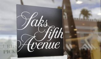 FILE - In this May 11, 2020 file photo, a Saks Fifth Avenue store remains closed on Worth Ave. during the new coronavirus pandemic in Palm Beach, Fla.  Saks Fifth Avenue is joining a growing list of retailers and brands including Macy’s, Versace and Prada that will stop using animal fur as it reacts to a backlash from consumers. Saks Fifth Avenue said Wednesday, April 7, 20201 that it will phase out using fur by the end of fiscal 2022. (AP Photo/Lynne Sladky, File)