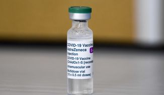 This Sunday, March 21, 2021, file photo shows a vial of the AstraZeneca COVID-19 vaccine at the Guru Nanak Gurdwara Sikh temple, on the day the first Vaisakhi Vaccine Clinic is launched, in Luton, England. A top official at the European Medicines Agency says there&#39;s a causal link between the AstraZeneca coronavirus vaccine and rare cases of blood clots, but he says the benefits of getting the vaccine still outweigh the risks, it was reported on Tuesday, April 6, 2021. (AP Photo/Alberto Pezzali, File)