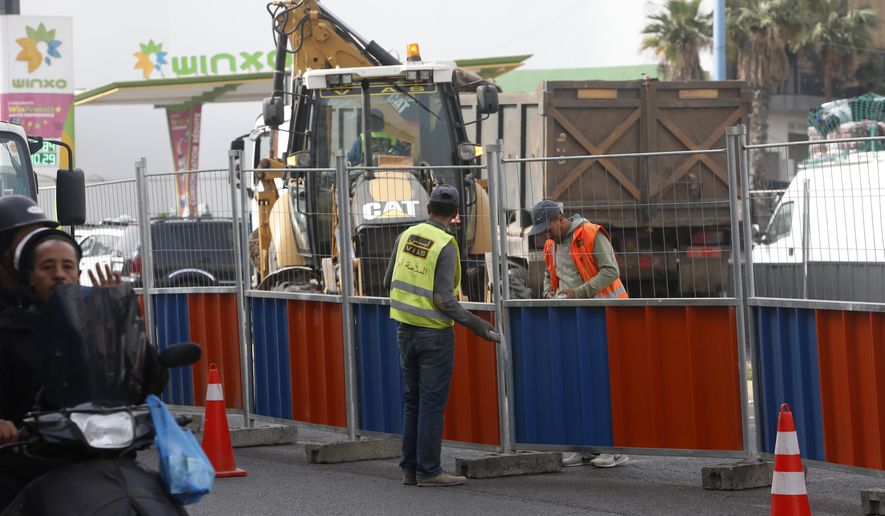 Workmen in Casablanca, Morocco, Tuesday, April 6, 2021. Moroccan authorities have announced the discovery of a new local variant of the coronavirus and extended an overnight curfew as infections rise again. (AP Photo/Abdeljalil Bounhar)